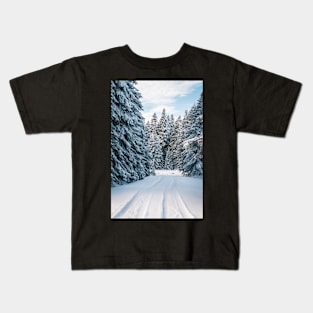 A photo of snow field near trees Kids T-Shirt